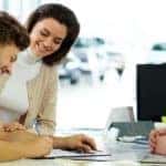 Beautiful young couple signs documents