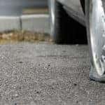 Car with flat tire sitting in a parking lot