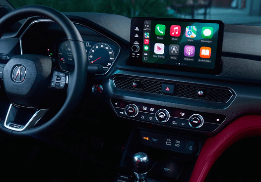 2026 Acura Integra cockpit with steering wheel, Apple CarPlay display, and manual shifter
