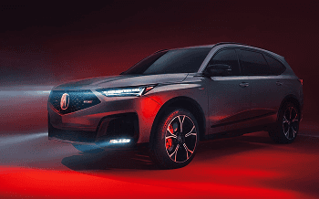 2026 Acura MDX front three-quarter studio shot with red ambient lighting