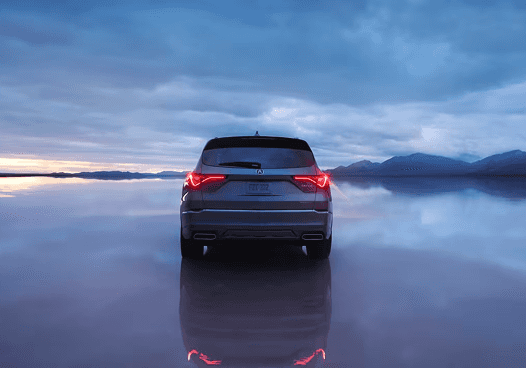 2026 Acura MDX rear view on reflective salt flats at sunset