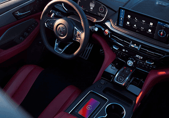 2026 Acura MDX interior with steering wheel, infotainment display, and red leather seats