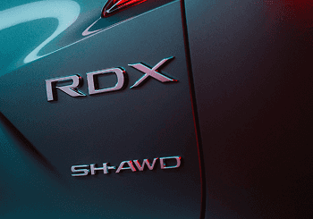 Close-up of 2026 Acura RDX rear badging with SH-AWD emblem