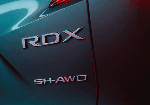 Close-up of 2026 Acura RDX rear badging with SH-AWD emblem