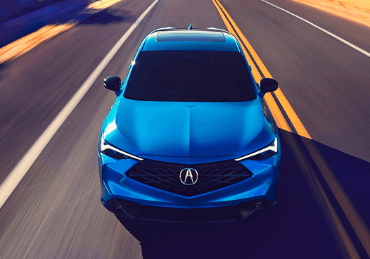 Top-down view of blue 2026 Acura ADX driving on a road