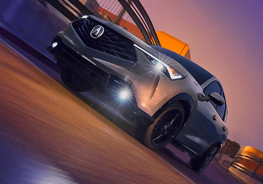 2026 Acura ADX in a dramatic studio setting with purple and orange lighting