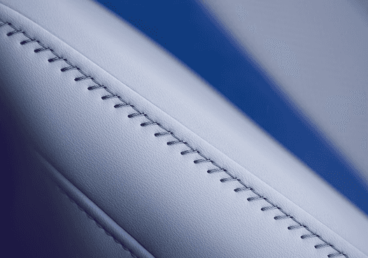 Close-up of 2026 Acura ADX white leather seat stitching with blue accent
