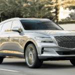 Genesis Gv80 drives in town with palm trees