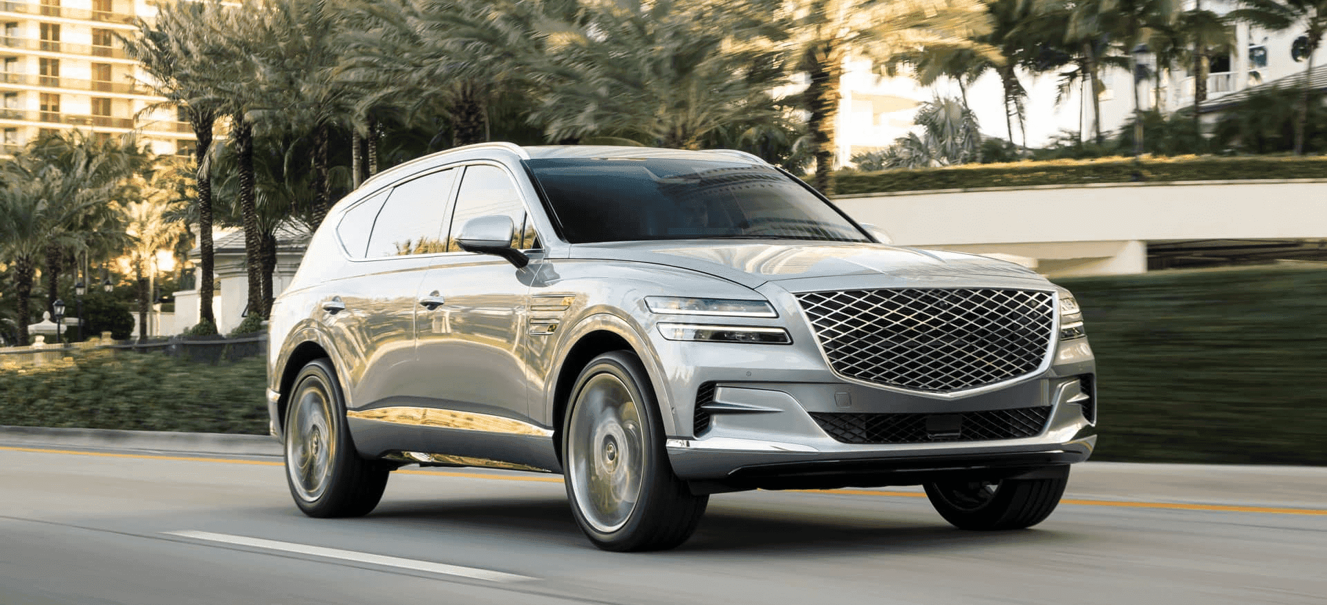 Genesis Gv80 drives in town with palm trees