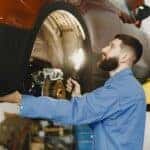 Man Checking on the Brakes of a Vehicle