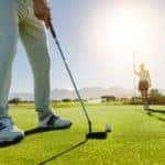 A close up of a man hitting a golf ball on a Mesa, AZ, golf course is shown.