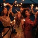A group of friends in Mesa, AZ, are dancing at night with sparklers.