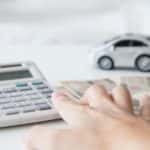 A person calculating their car finance and budget