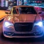 A view of the 2023 Chrysler 300S from the front, illuminated at night