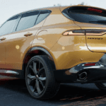A three-quarters rearview of a yellow 2023 Dodge Hornet