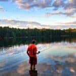 Boy in red shirt fishing at Myles Standish State Forest near Plymouth, MA