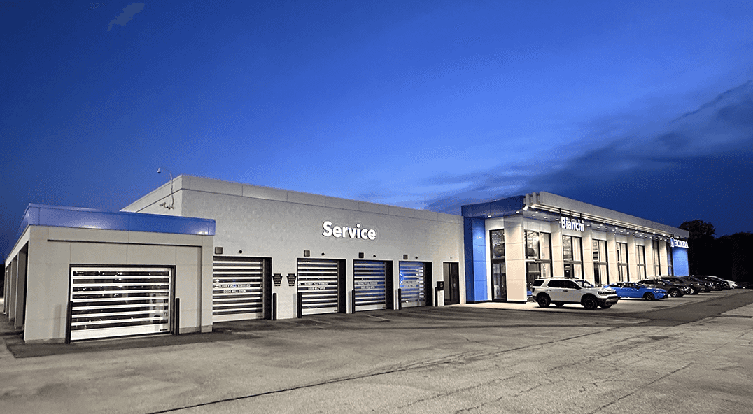 Bianchi Honda Service Drive at night with 4 closed garage doors to show an area of work for a career in automotive