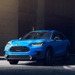 2026 honda hr-v in boost blue pearl in a dark setting by a building