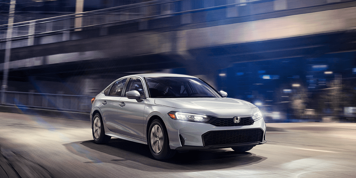 2026 honda civic lx in solar silver in a night city backdrop