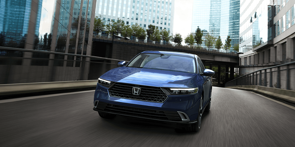 2026 Honda Accord in Canyon Blue Metallic front view driving in a city scape