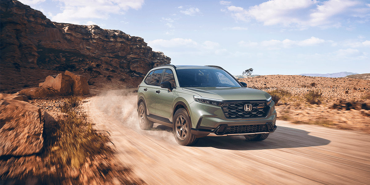 2026 honda cr-v trailsport in ash green metallic driving down a desert road