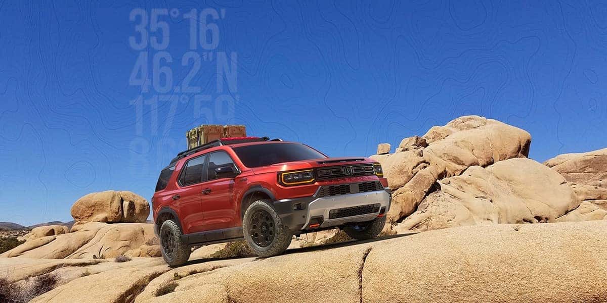 2026 Honda Passport TrailSport in Radiant Red in a desert rock setting with a topographical map and co-oridinate overlay
