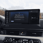 Google Gemini AI Assistant displayed on a touchscreen in a Honda with a mountain view out the window behind it.