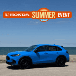 2027 Honda HR-V AWD in Boost Blue Pearl parked in front of Lake Erie. Honda Summer Event logo overlayed in the sky.