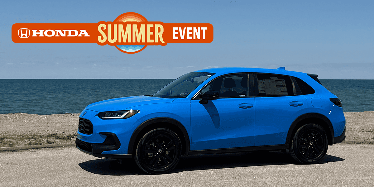 2027 Honda HR-V AWD in Boost Blue Pearl parked in front of Lake Erie. Honda Summer Event logo overlayed in the sky.