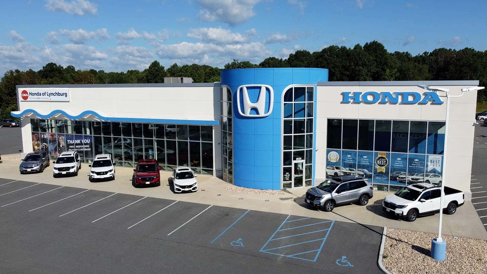 An exterior shot of a Honda dealership at night.