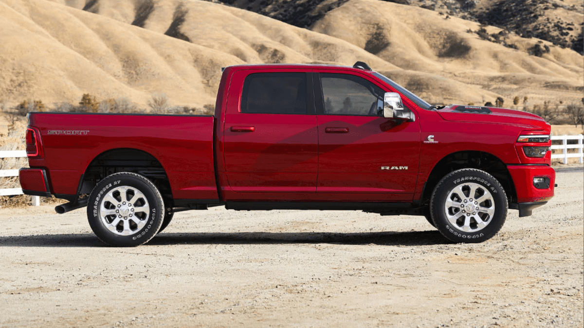 A red RAM 2500 in profile on a ranch in the desert