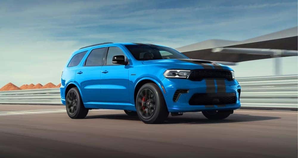 A bright blue 2026 Dodge Durango SUV at a race track