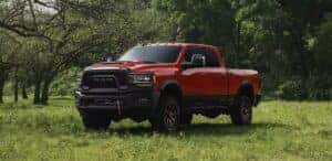 red 2023 RAM 2500 parked in a field of grass