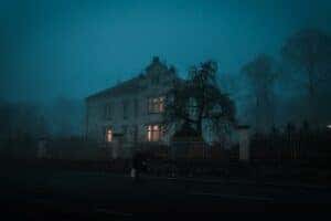 haunted house in a mist of fog in a gloomy night