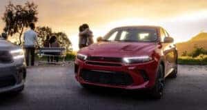 red 2024 dodge hornet parked in front of a sunset