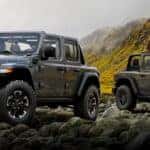 two 2024 jeep gladiator parked on rocks