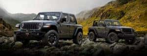 two 2024 jeep gladiator parked on rocks