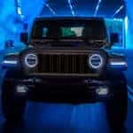 front view of a black 2024 Jeep Wrangler 4xe driving through a tunnel