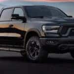 black 2024 ram 1500 parked at an angle on asphalt road.
