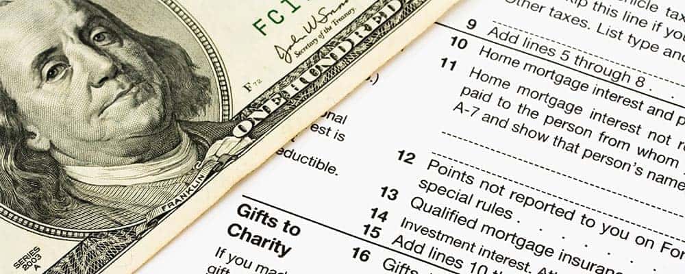 Tax Form and Hundred Dollars