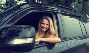 Woman in SUV on rainy day