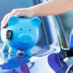blue piggy bank on the hood of a blue car