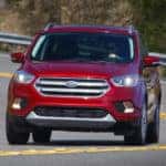 Man driving Red Ford SUV
