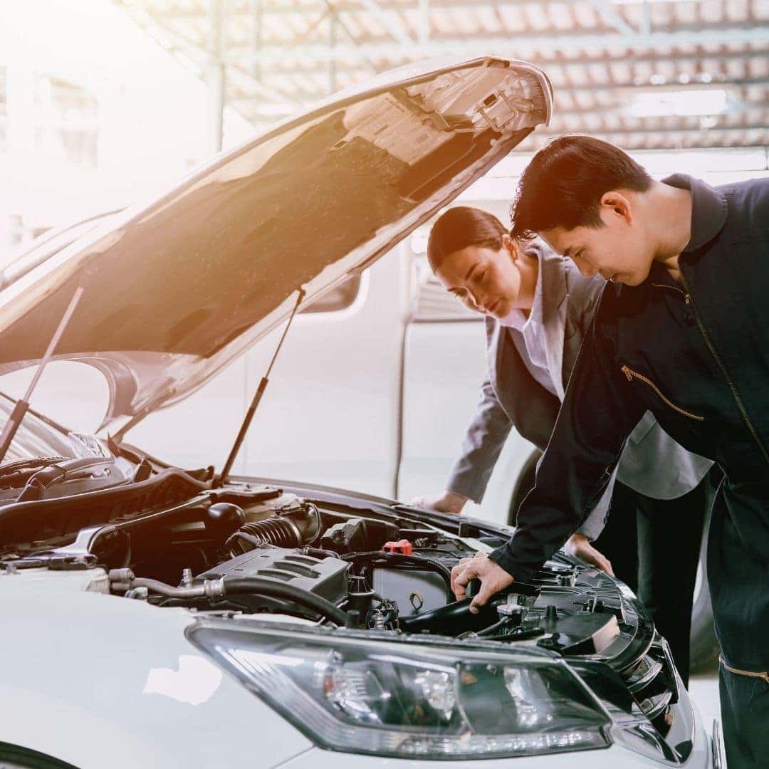 vehicle technicians talking with client