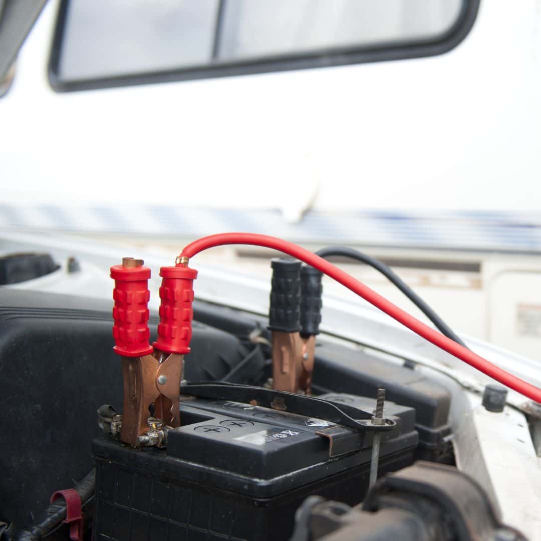 jumper cables hooked to a battery