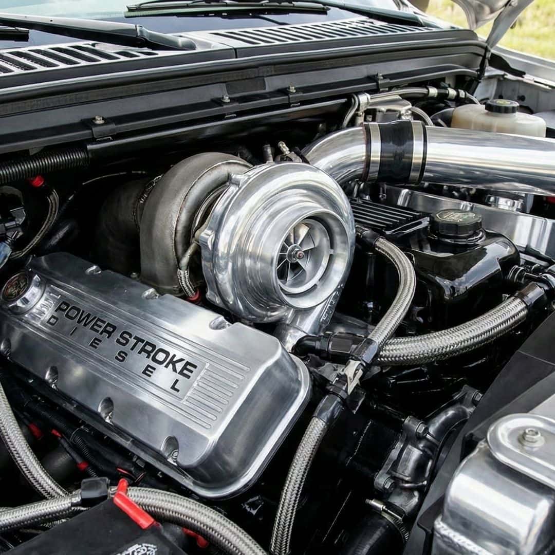 Close-up photograph of a clean, powerful pickup truck diesel engine bay.