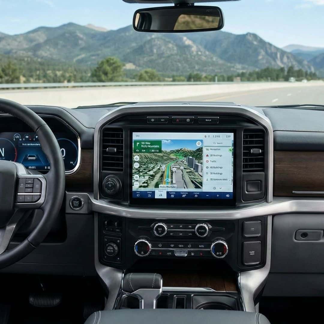 Modern pickup truck dashboard with a large infotainment touchscreen displaying a navigation map.