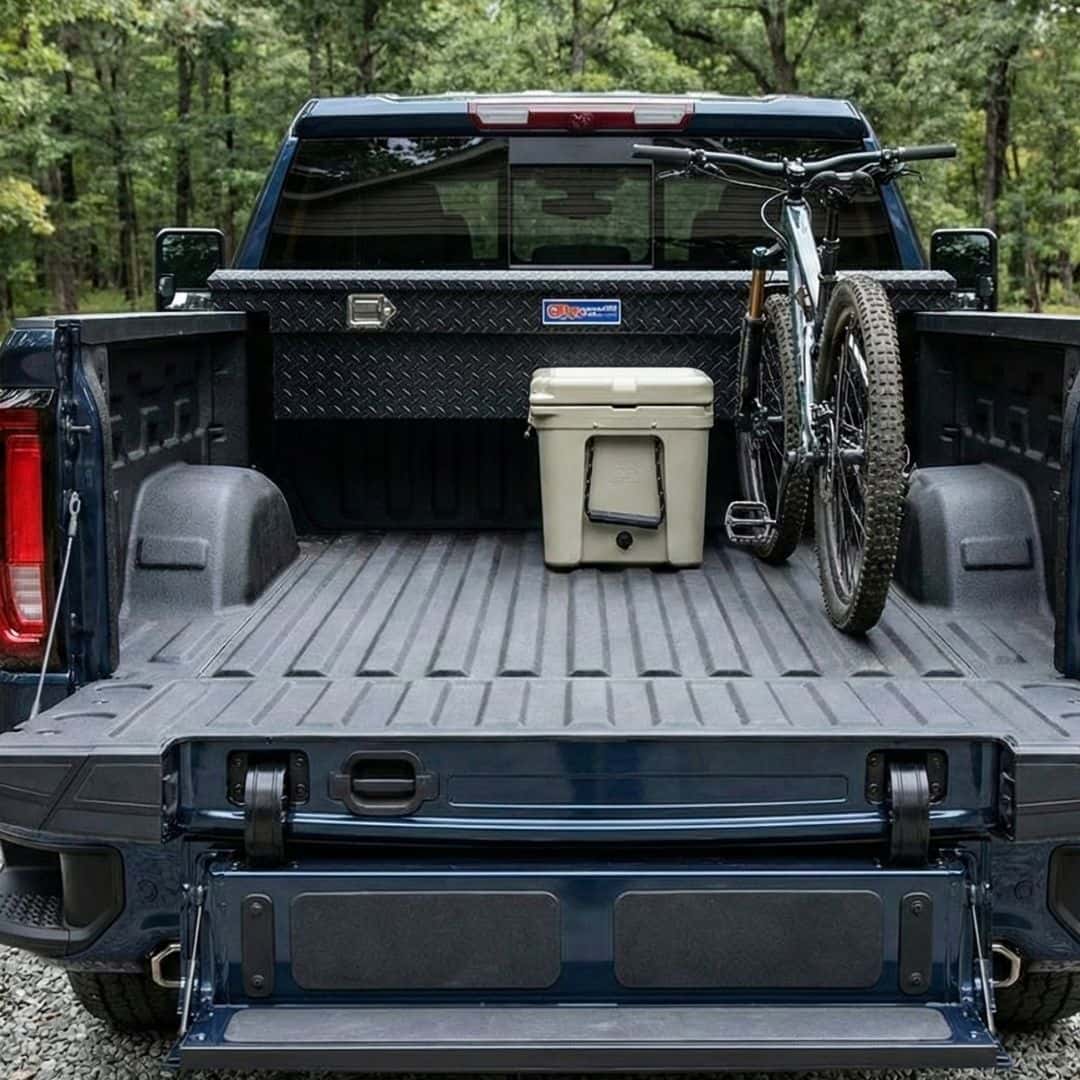 Pickup truck bed with a multi-function tailgate folded down into a step.