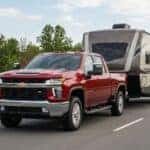 red chevy truck hauling an RV