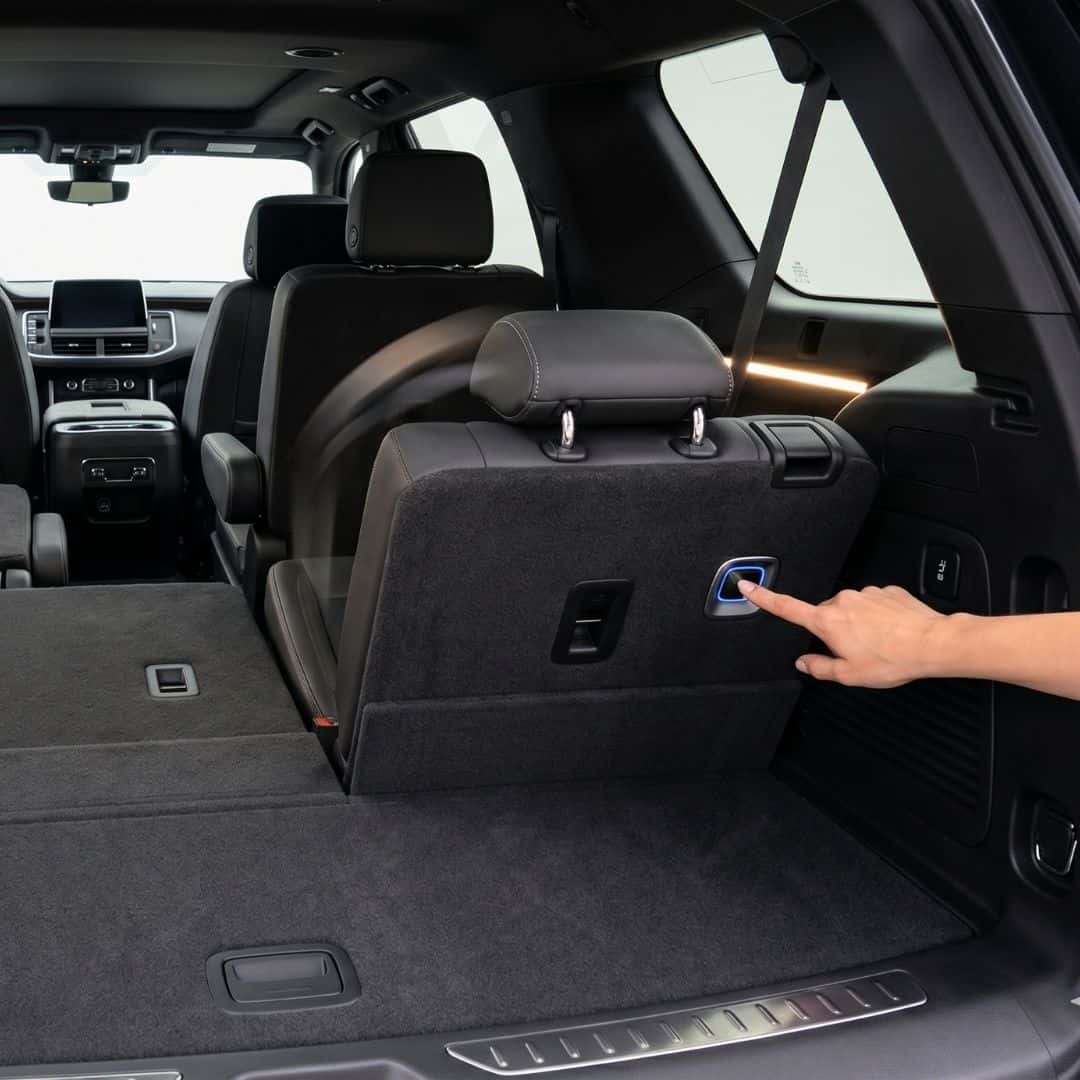 Close-up of the power-folding third-row seats opening up massive flat cargo space inside a Chevy SUV.